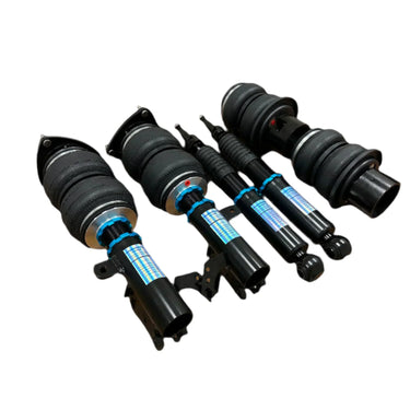A set of black Dreworkz air ride struts with blue accents, including wiring harnesses and optional air compressor components.
